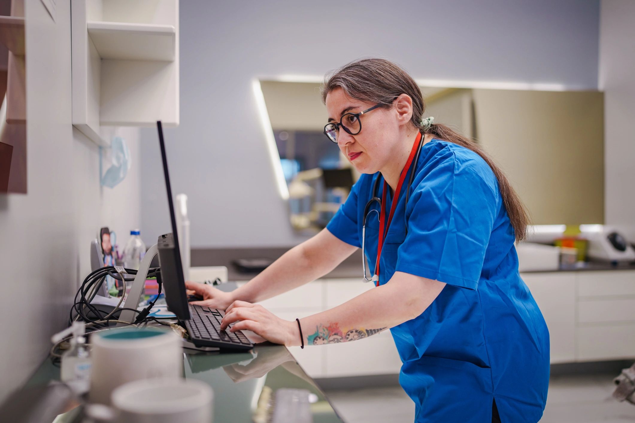 Clinic staff member at reception desk